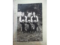 Old photo of three men on a bench - 1