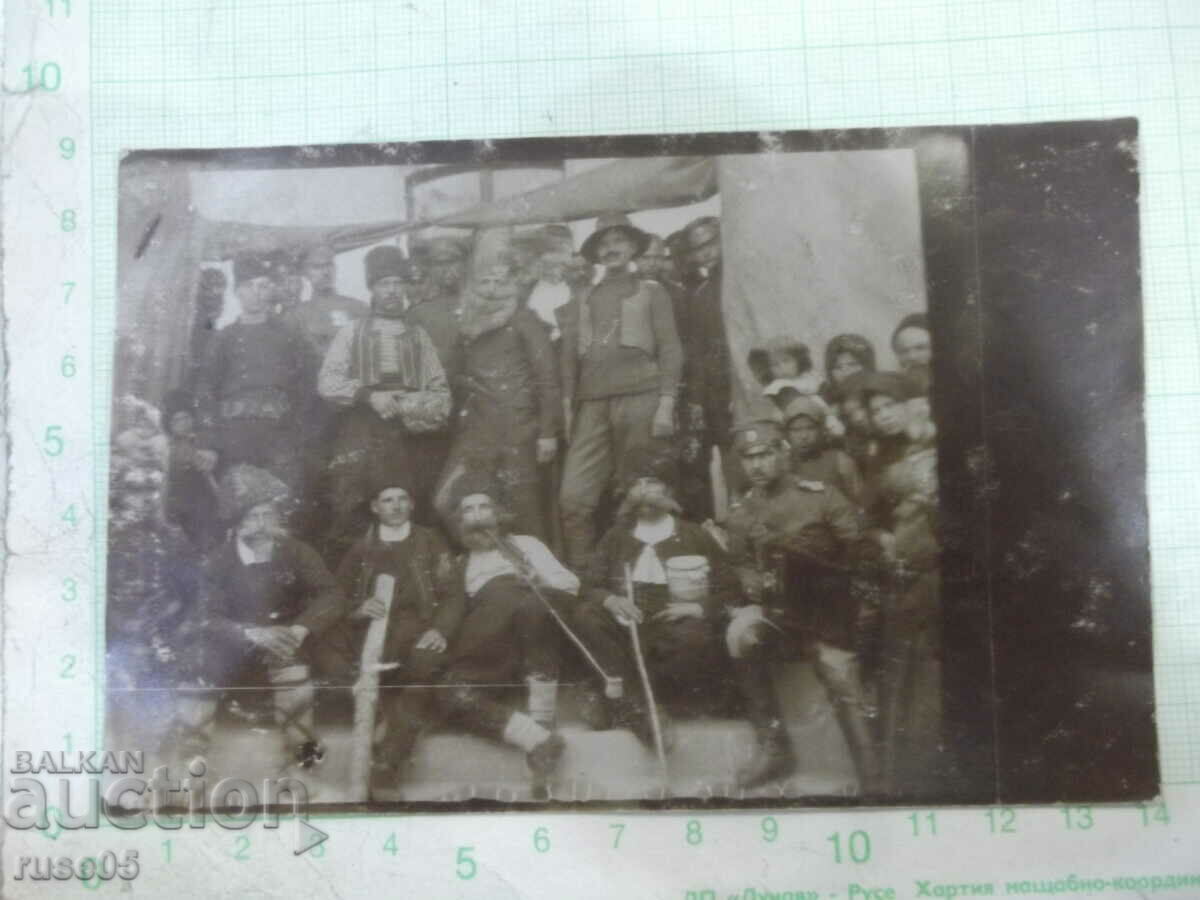 Old photo of villagers with soldiers