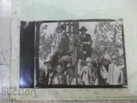 Old photo of young people in front of the monument