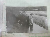 Old photo of two young women on the river