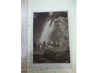 Old photo of a group in front of the waterfall