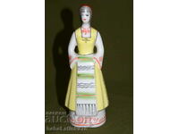 An interesting hand-painted porcelain figurine