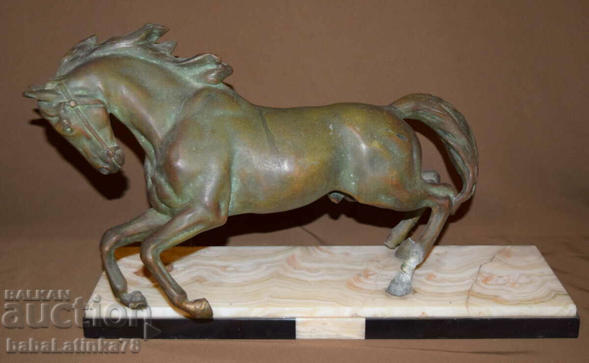 Metal sculpture of a horse with a marble base