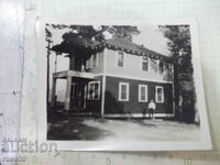 Old photo of a Bulgarian man in front of a house in America