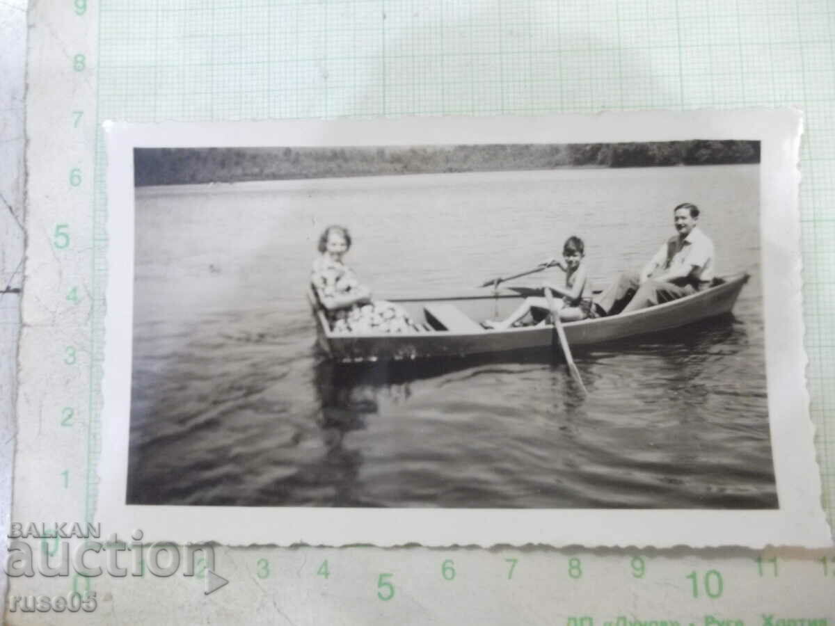 Old photo of a family with a boat in America