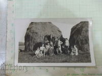 Old photo of Bulgarians in front of harvested straw in America