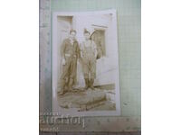 An old photo of two Bulgarians in front of the door of a house in America