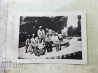 An old photo of a group of Bulgarians sitting in a fountain in America