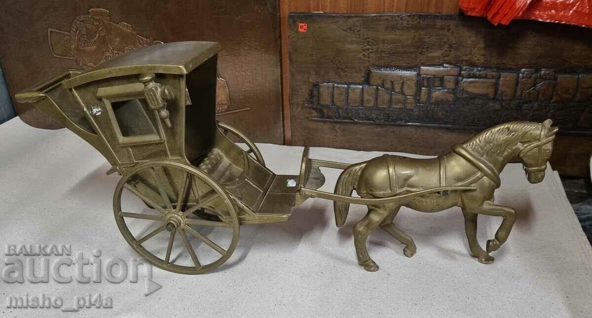 a massive bronze horse with a carriage