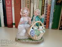 Porcelain figurine girl and boy with basket, lace