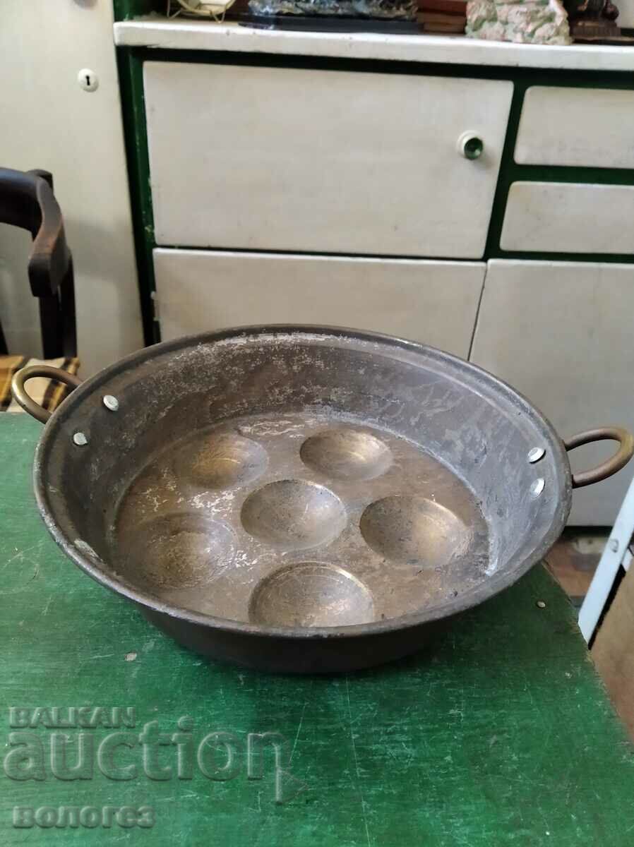 Antique copper vessel for cooking eggs