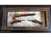 Copies of old weapons in a frame