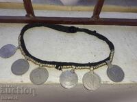 Old ethnographic jewelry with coins