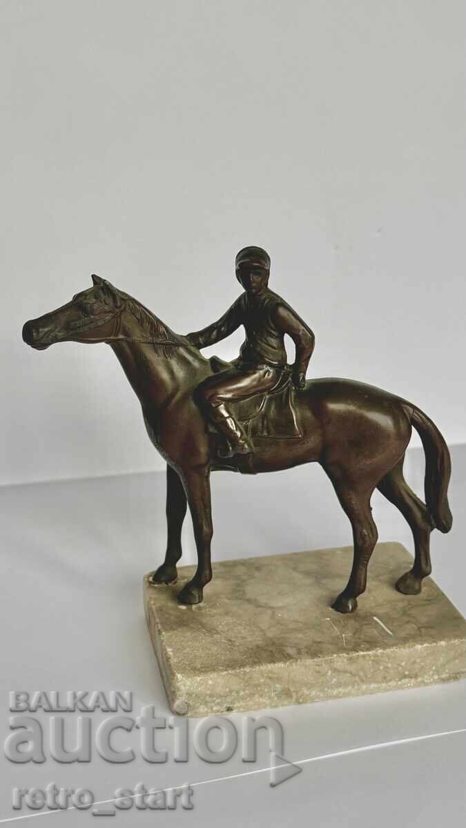 Metal figure of a jockey with a horse