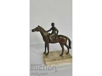 Metal figure of a jockey with a horse