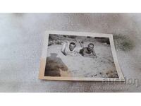 Photo Two men lying on the sand