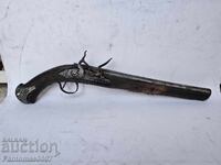 An old flintlock pistol, a pistol.