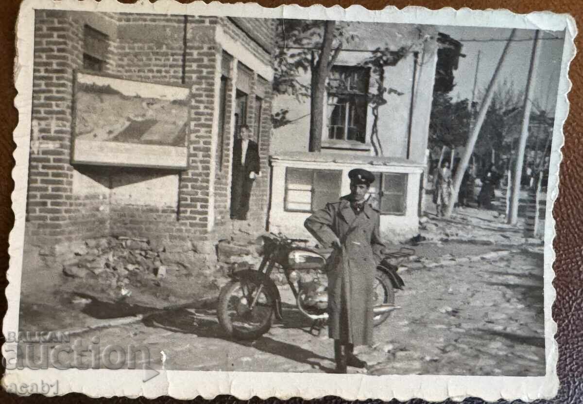 A soldier in front of his motorbike