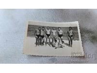 Photo Men and two children on the beach 1954