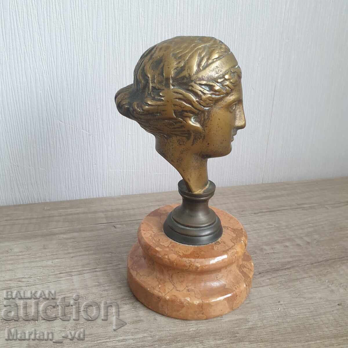 Delivery of Old bronze sculpture of a woman on marble