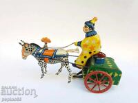 Old metal toy circus clown with wind-up mechanism