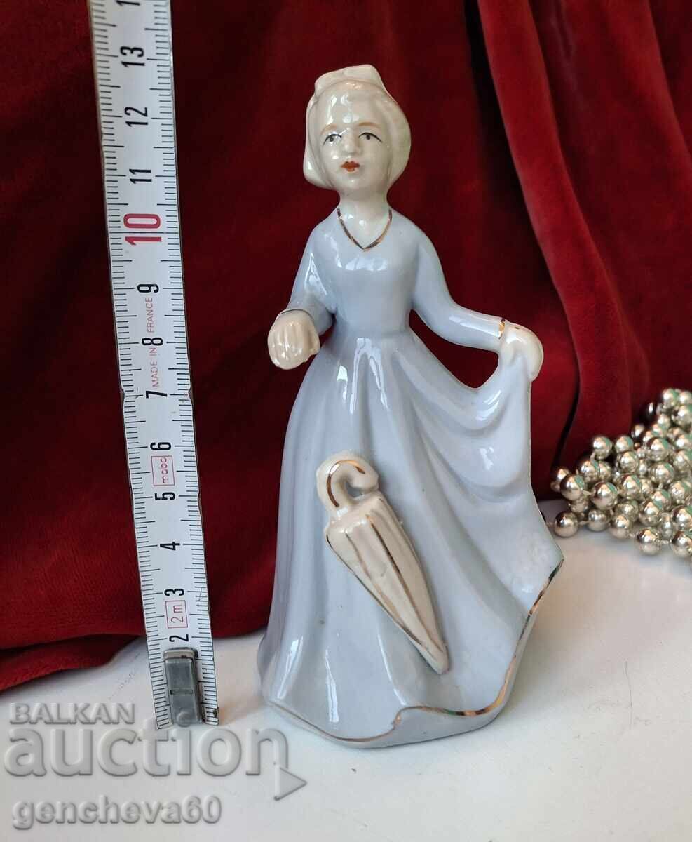 Porcelain figure of a lady with an umbrella Porcelain figure of a lady with an umbrella