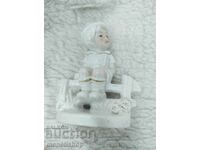 Boy on a bench figurine - old porcelain