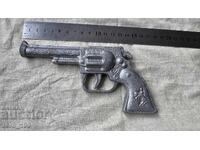 A children's toy gun, cast from soda.