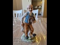 Old man with a hen figurine