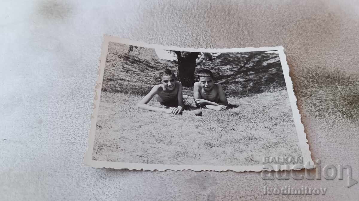 Photo Two boys lying on the grass Photo Two boys lying on the grass