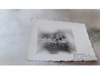 Photo Two women and two little girls on a rock in the sea