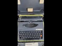 Typewriter with two ribbons and a suitcase