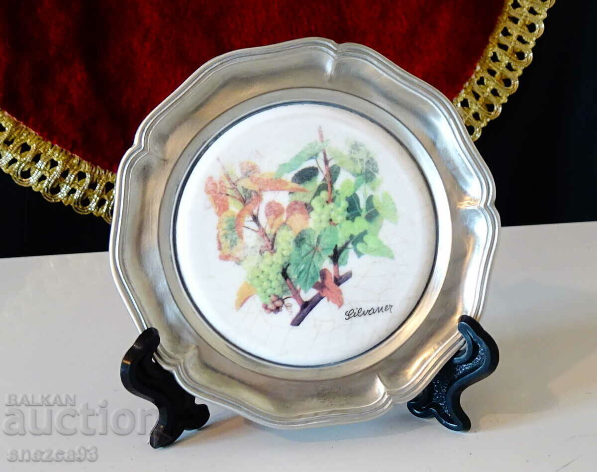 A pewter plate with a variety of vines, marked. A pewter plate with a variety of vines, marked.