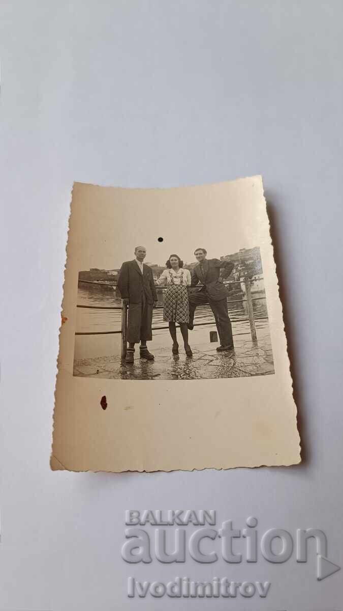 Photo Two men and a young girl on the pier Photo Two men and a young girl on the pier