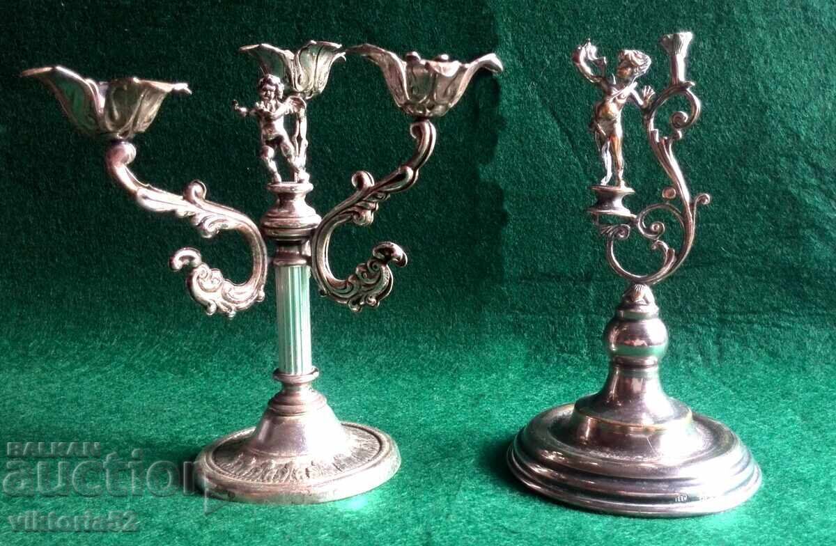 Miniature old silver-plated candlesticks with a cherub-angel Miniature old silver-plated candlesticks with a cherub-angel