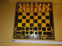 Old beautiful wooden chess set with carvings and backboard