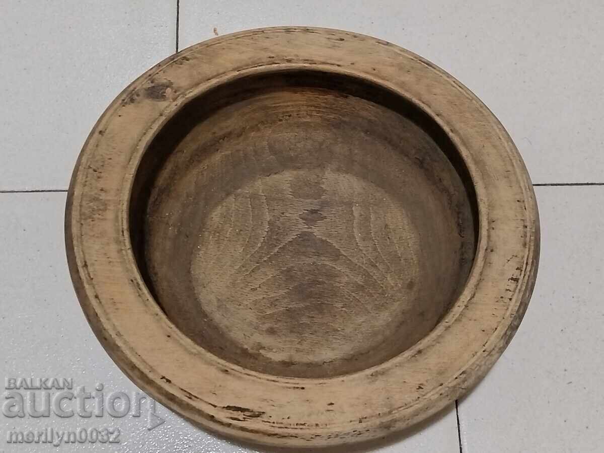 A wooden bowl, panica, a wooden pan A wooden bowl, panica, a wooden pan