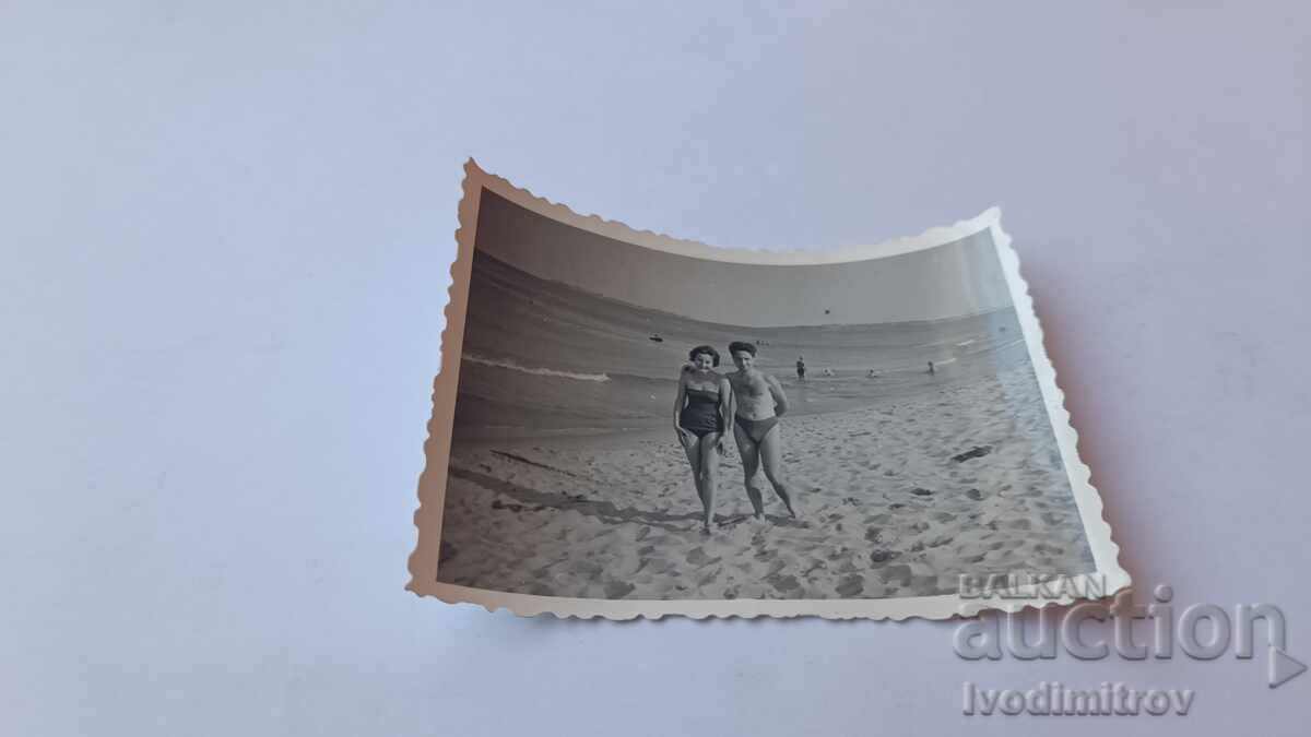 Photo Young girl and young man on the beach Photo Young girl and young man on the beach