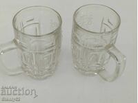 2 thick glass beer mugs with a Lion emblem