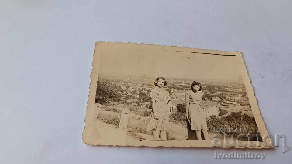 Photo of Two Young Women Above the Village