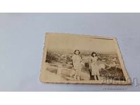 Photo of Two Young Women Above the Village