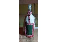 A bottle dressed in traditional costume for connoisseurs