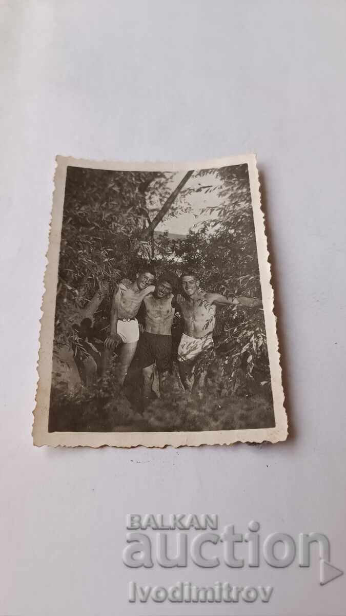 Photo of Three Young Men in Shorts Photo of Three Young Men in Shorts