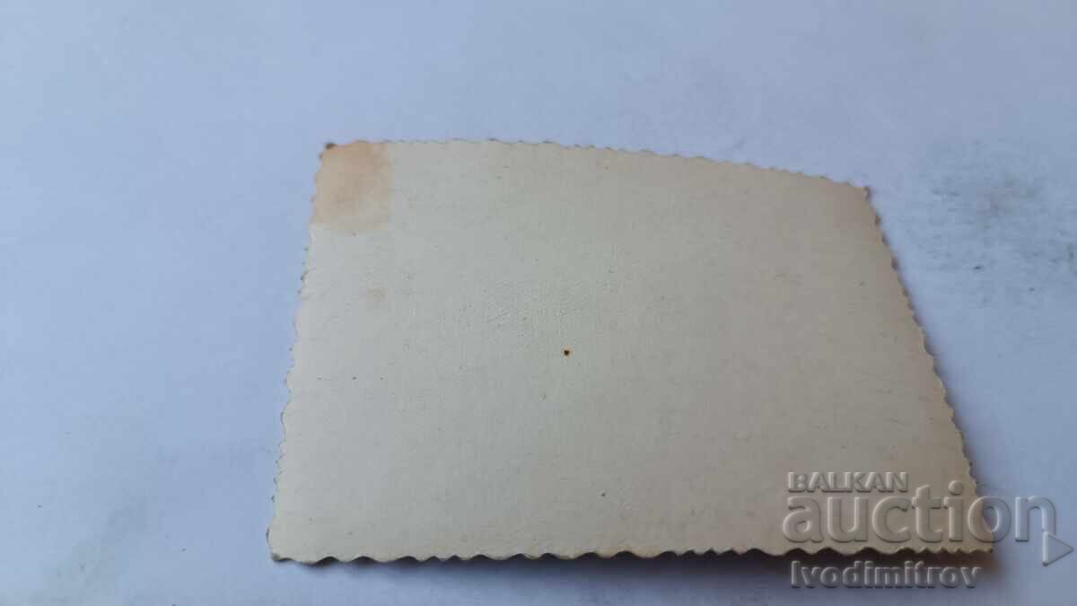 Photo of a young woman sitting on a rock by the sea with price 1.65 BGN | € 0.84