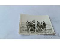 Φωτογραφία Νέων και κοριτσιών σε βράχους στην παραλία