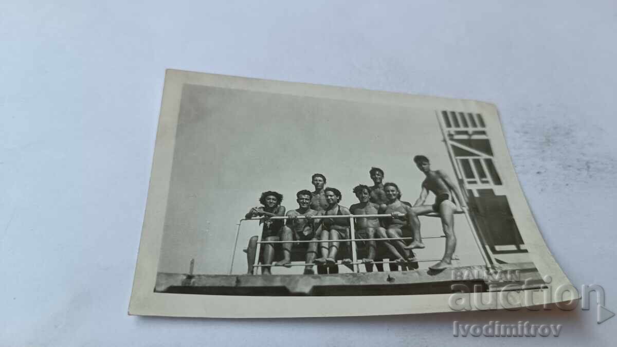 Photo of Young Men and Women at the Pier
