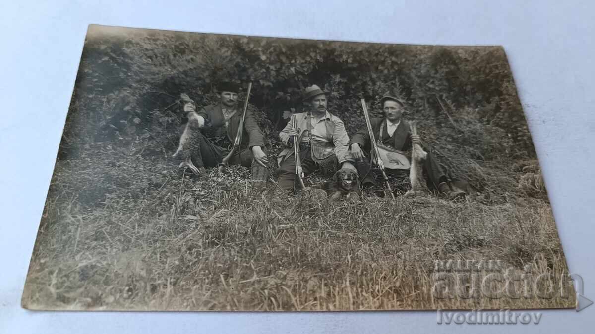 Photograph of Three Hunters with a Hunting Dog and Two Trophy Hares Photograph of Three Hunters with a Hunting Dog and Two Trophy Hares
