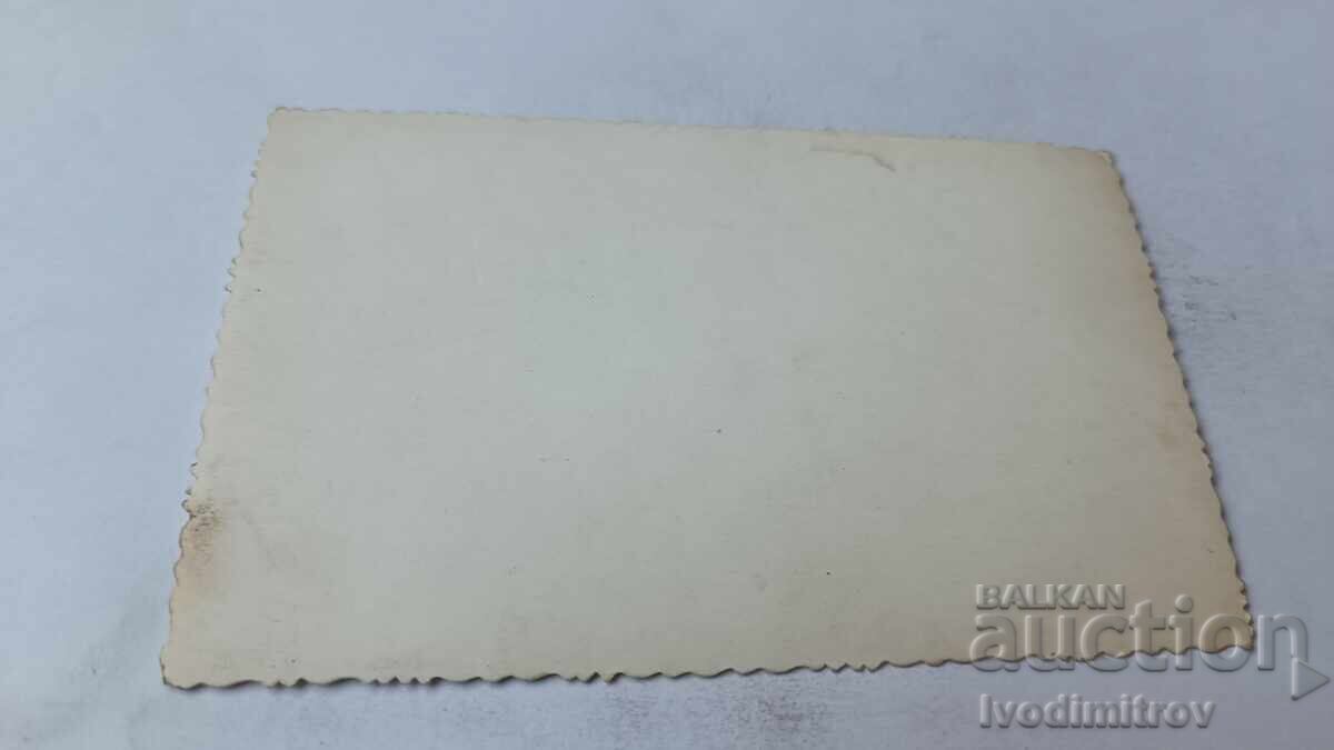 Photo of a young man with a retro motorcycle with license plate Sofia 23656 smoking a cigarette with price 2.45 BGN | € 1.25