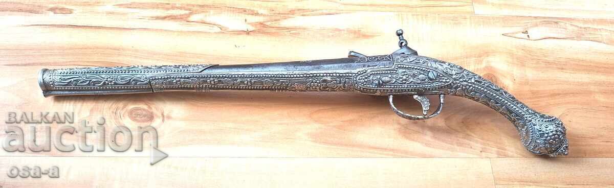 Auction  A pistol, a rifle, a revolver