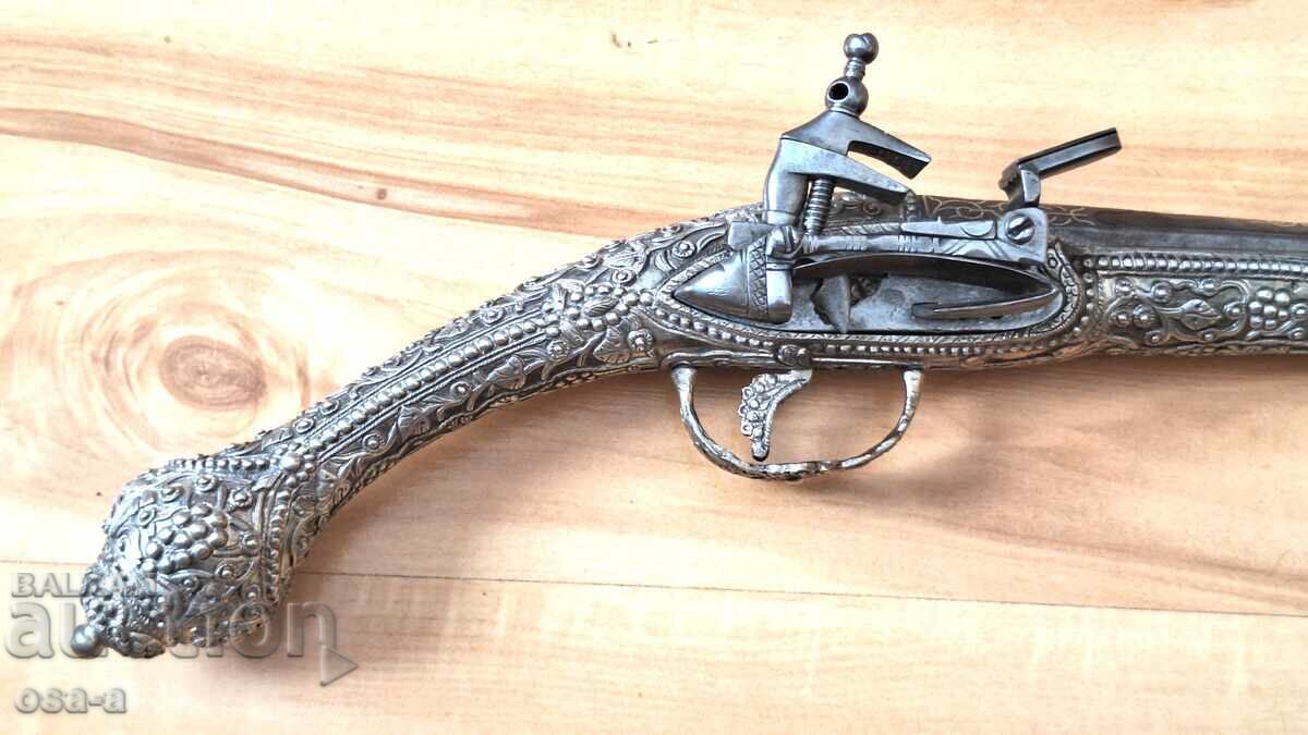 A pistol, a rifle, a revolver